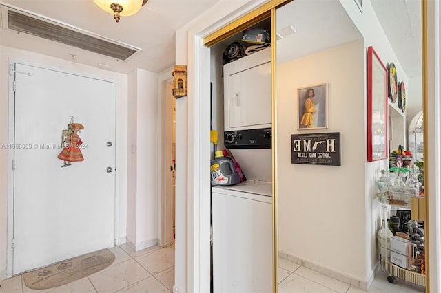 washroom featuring stacked washer and clothes dryer