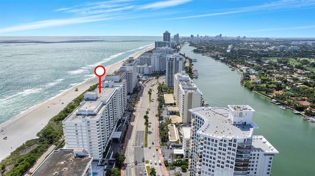 aerial view with a water view and a view of the beach