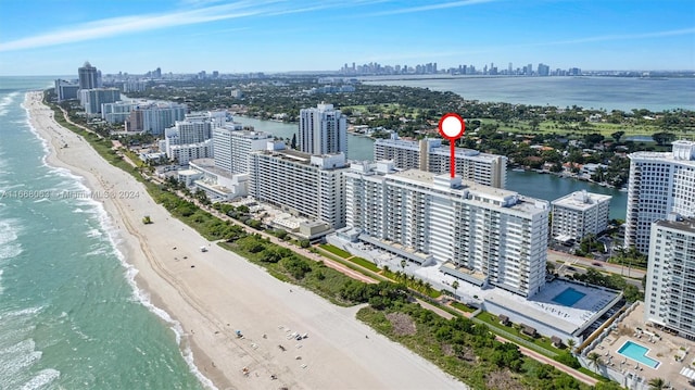 birds eye view of property with a view of the beach and a water view