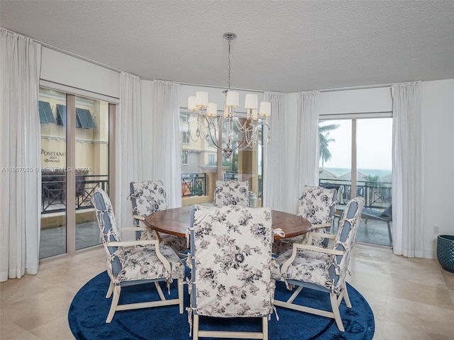 dining room with a chandelier and a textured ceiling