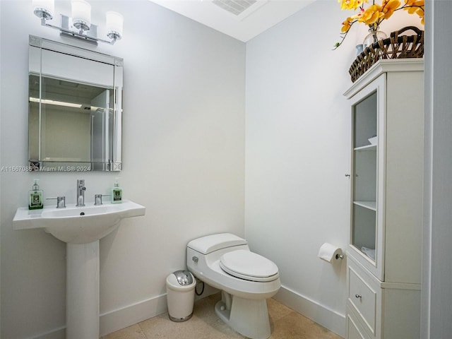 bathroom featuring tile patterned flooring and toilet