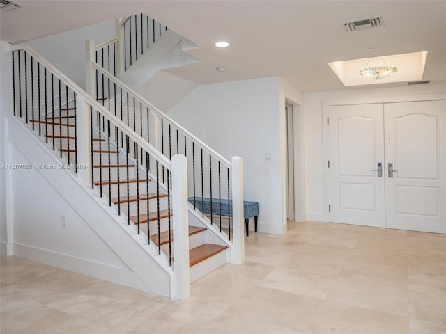 foyer with a chandelier and french doors