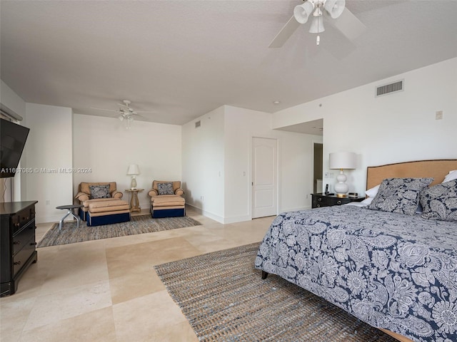 bedroom with a textured ceiling and ceiling fan