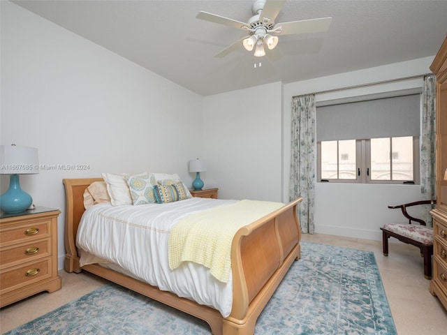 bedroom featuring ceiling fan and light carpet