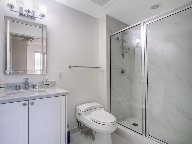 bathroom featuring vanity, toilet, and an enclosed shower