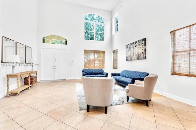 interior space featuring light tile patterned flooring and baseboards