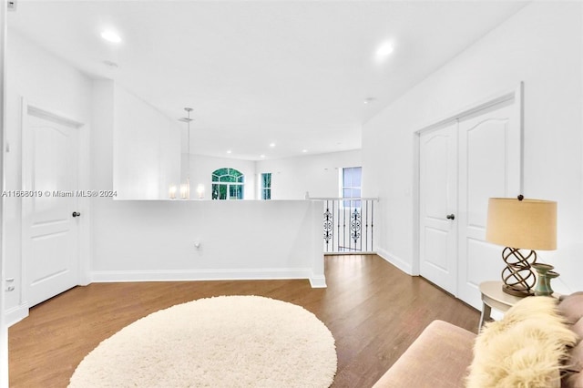 spare room with hardwood / wood-style floors and a chandelier