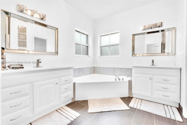 bathroom featuring vanity and a bath