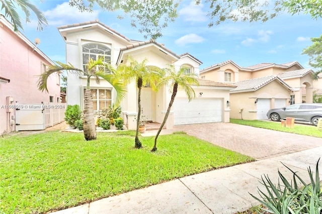 mediterranean / spanish-style home with a front lawn and a garage