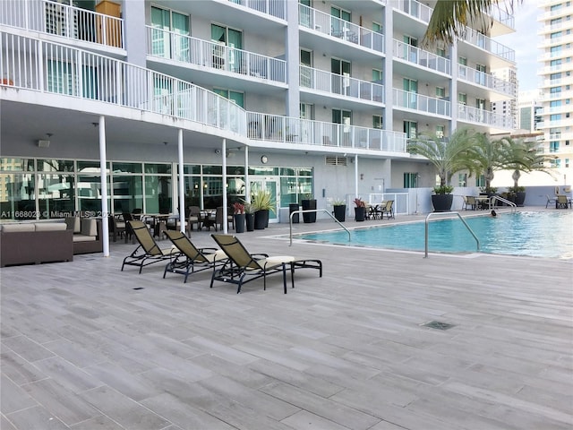 view of swimming pool featuring a patio and an outdoor hangout area