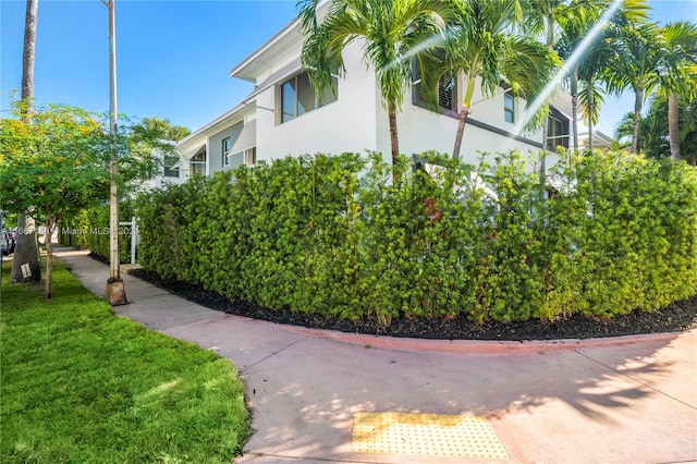 view of side of property with a lawn