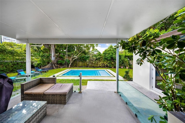 view of pool featuring a lawn and a patio area