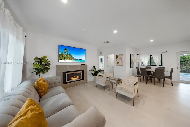 living room featuring a tiled fireplace