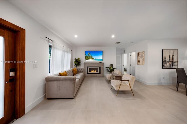 living room with a tiled fireplace