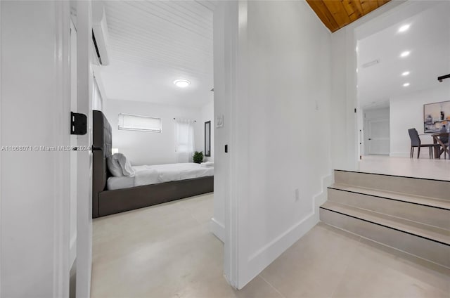 corridor featuring wood ceiling and a wall mounted air conditioner