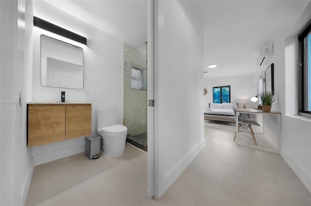 bathroom with concrete flooring, vanity, toilet, and a shower with door