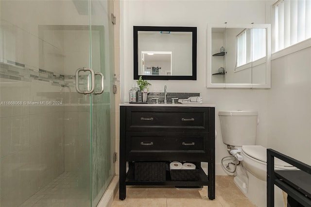 bathroom featuring vanity, tile patterned flooring, toilet, and an enclosed shower