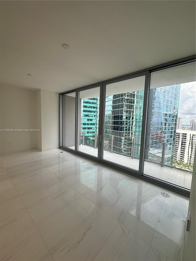 unfurnished room with floor to ceiling windows