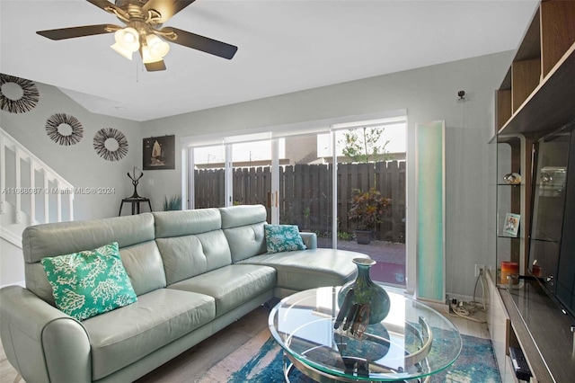 living room featuring wood-type flooring and ceiling fan