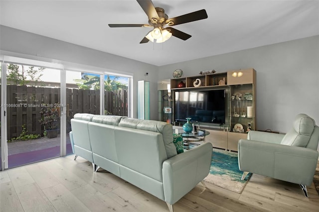 living room featuring light hardwood / wood-style flooring and ceiling fan