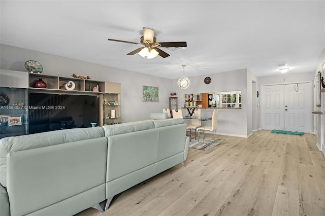 living room featuring light hardwood / wood-style floors and ceiling fan