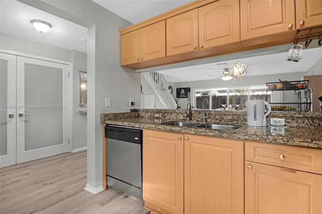 kitchen with light hardwood / wood-style floors, dishwasher, light brown cabinets, dark stone counters, and sink