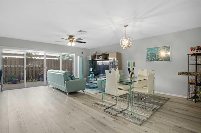 unfurnished dining area featuring ceiling fan with notable chandelier and hardwood / wood-style flooring