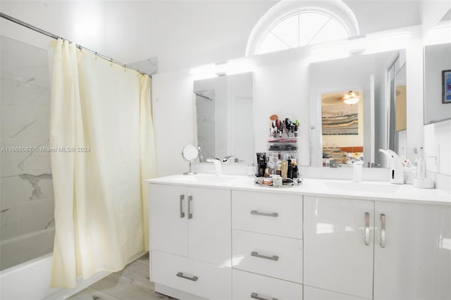 bathroom featuring vanity, hardwood / wood-style floors, and shower / bathtub combination with curtain