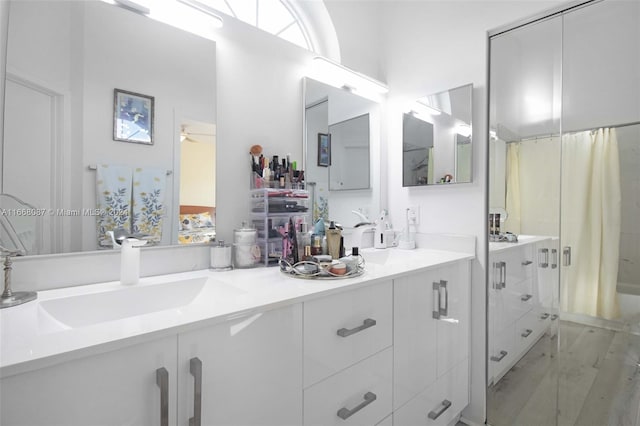 bathroom featuring hardwood / wood-style floors, vanity, and a shower with shower curtain