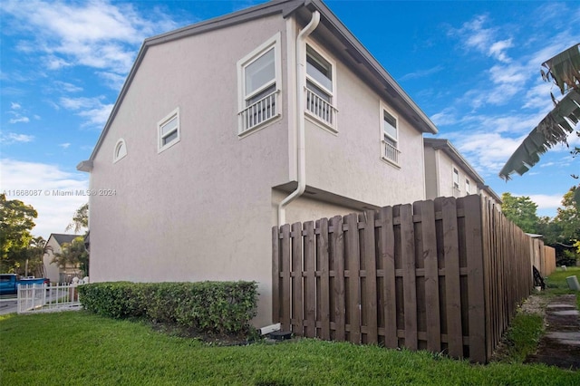 view of side of property with a lawn