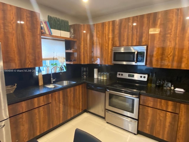 kitchen with light tile patterned flooring, backsplash, stainless steel appliances, and sink