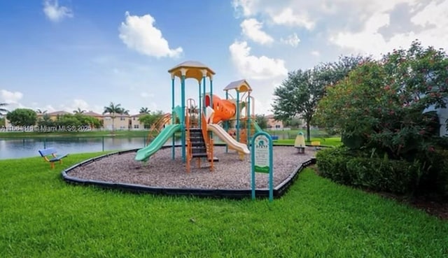 view of play area with a lawn and a water view