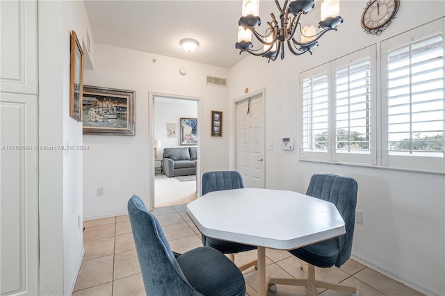 dining space featuring a notable chandelier and light tile patterned floors