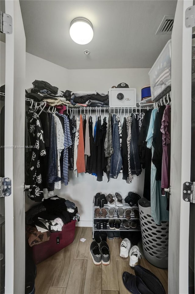 spacious closet with hardwood / wood-style floors