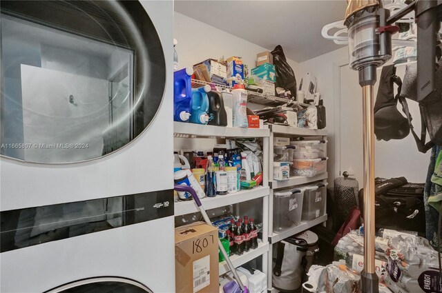 clothes washing area featuring stacked washer / drying machine