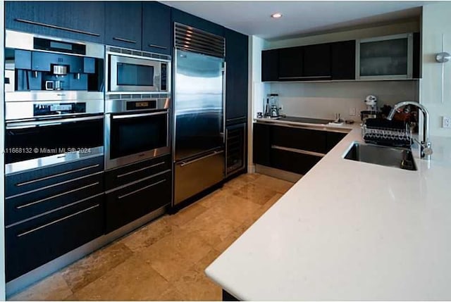 kitchen with built in appliances and sink