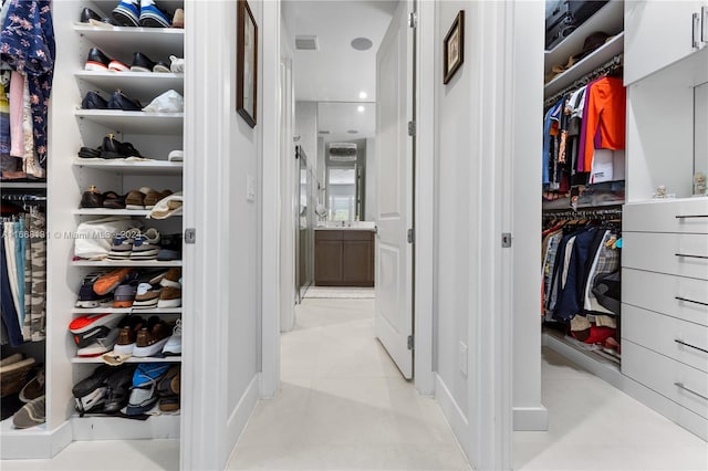 spacious closet featuring light tile patterned floors