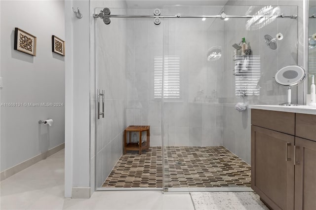 bathroom featuring vanity, tile patterned floors, and walk in shower