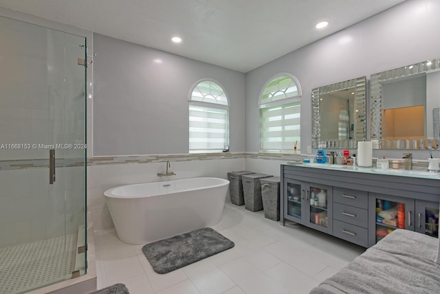 bathroom featuring shower with separate bathtub, tile patterned flooring, and vanity