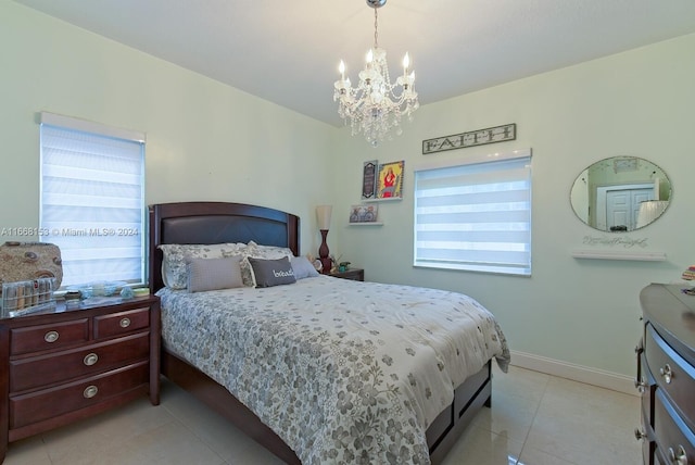 bedroom with light tile patterned flooring and an inviting chandelier