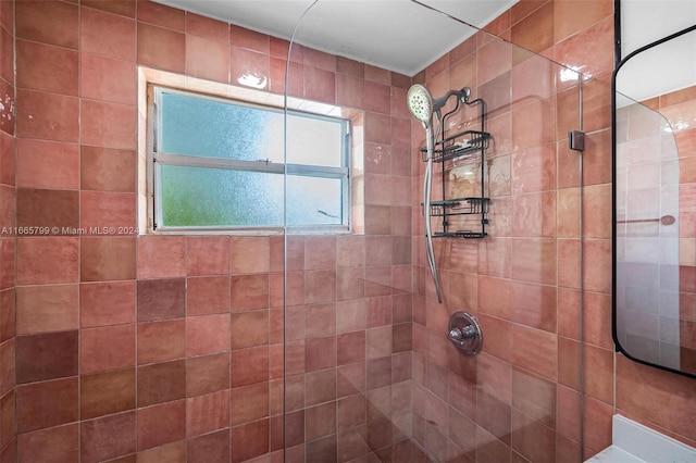 bathroom with tiled shower