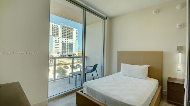 bedroom with light hardwood / wood-style flooring and access to exterior