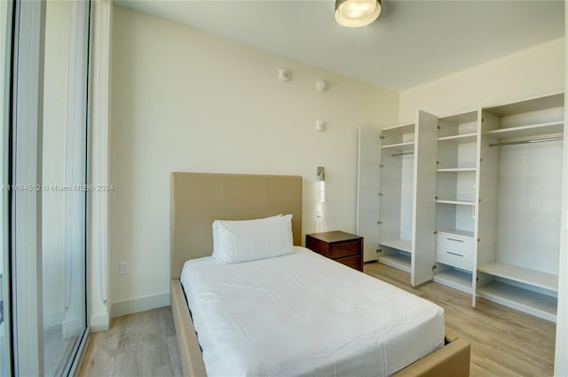 bedroom featuring light wood-type flooring and a closet