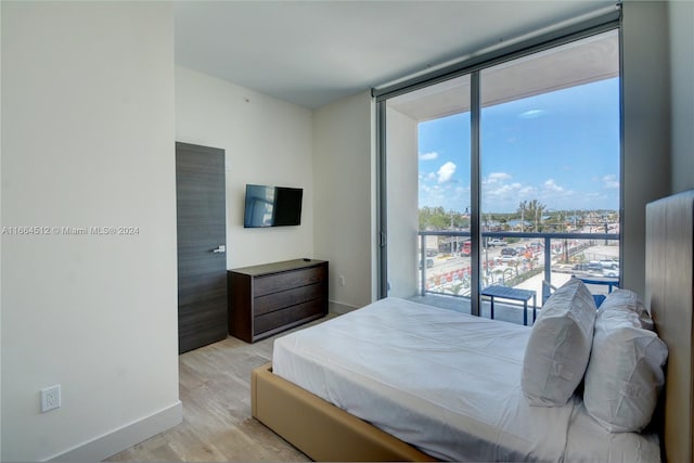 bedroom featuring light hardwood / wood-style floors and multiple windows