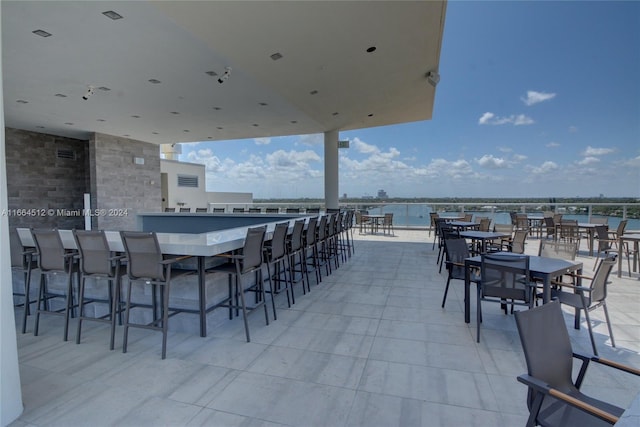 view of patio / terrace with an outdoor bar and a water view