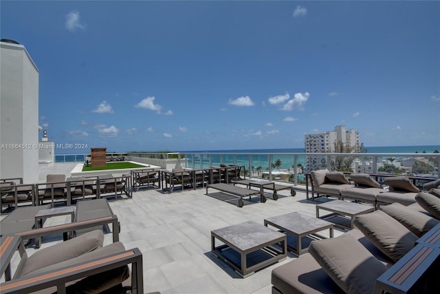 view of patio / terrace featuring a balcony, a water view, and outdoor lounge area