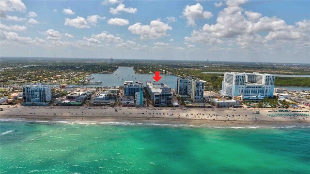 drone / aerial view with a water view and a view of the beach