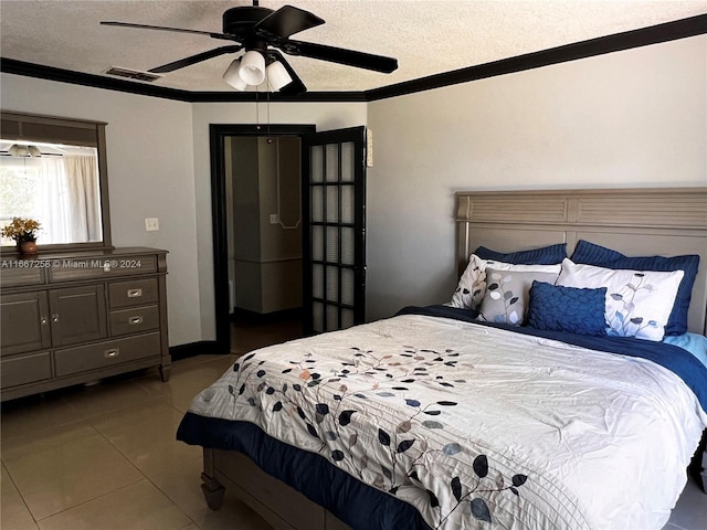 bedroom featuring ceiling fan, a textured ceiling, crown molding, and tile patterned flooring