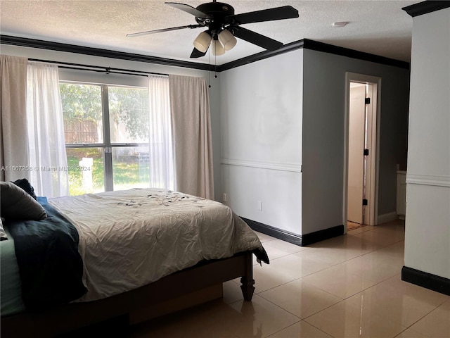 bedroom featuring a textured ceiling, ceiling fan, light tile patterned floors, and crown molding