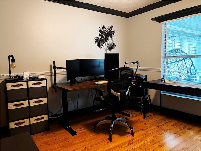 office area with ornamental molding and hardwood / wood-style floors